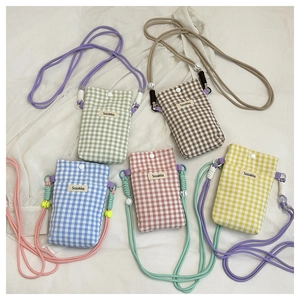 Detailed view of 5 colorful checkered mini crossbody bags with woven rope straps
