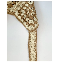 Macro detail of grandmother square crochet pattern in beige and cream cotton blend