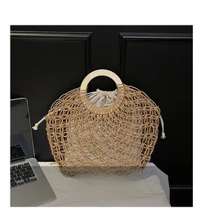 Detailed view of hollow woven beach bag with round wooden handle and drawstring liner