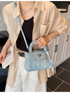 Chic light blue denim mini bucket bag with quilted texture and heart-shaped silver lock