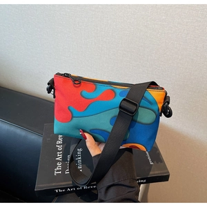 Detail showing colorful wavy patterned polyester crossbody bag with adjustable strap