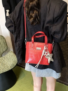 Red crocodile texture tote bag with star and balloon dog charm for stylish women