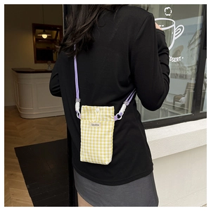 Detailed back view of a yellow checkered canvas phone bag with purple rope strap