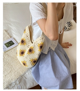 Close-up of handmade crochet sunflower shoulder bag with woven floral patterns
