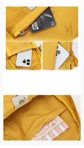 Detail view of yellow nylon crossbody bag featuring multi-pocket storage and printed lining