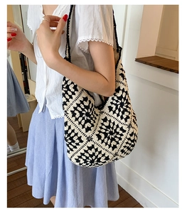 Close-up of black and white hand-crocheted floral pattern on the large tote bag