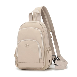 Detail view of khaki nylon crossbody bag featuring front zipper pockets and side pockets