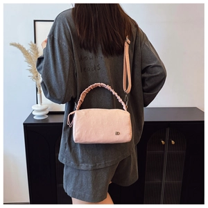 Detail showing pink pleated texture and metal logo on this stylish boston shoulder bag