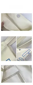 Detail view of cream canvas tote bag showing magnetic buckle and inner pocket compartment