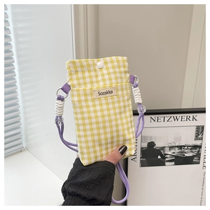 Detail of yellow gingham canvas phone bag with purple strap and Sozakka label