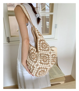 Detail of hand-woven crochet tote bag with geometric floral patterns and inner lining