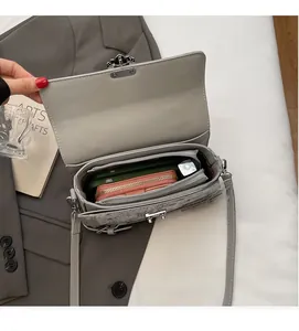 Interior view of grey patterned crossbody bag showing space for phone and wallet