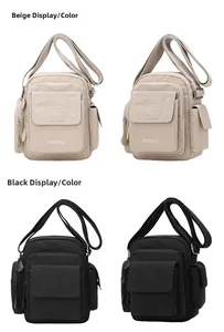 Detail view of multi-pocket crossbody bags in beige and black with adjustable straps