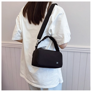 Detail of black crossbody Boston bag featuring cloud-style pleated handle and DD logo
