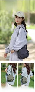 Multi-pocket nylon crossbody bag with adjustable wide strap shown in casual outdoor setting