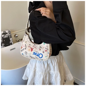 Detail of graffiti print croissant bag featuring colorful letters and adjustable strap