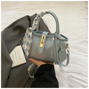Light blue PVC bucket bag detail with inner pouch and silk scarf handle decoration