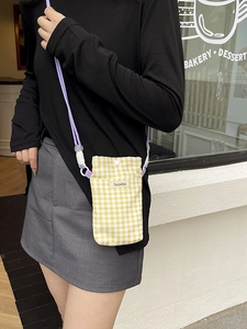 Yellow and white checkered canvas phone crossbody bag with purple straps and logo detail