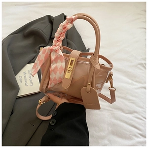 Pink jelly bucket bag detail with plaid scarf handle and gold turn-lock closure