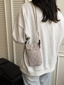 Vertical checkered canvas crossbody phone bag for women with adjustable strap and snap button