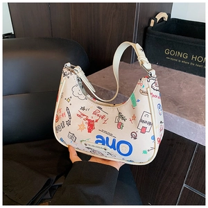 Close-up of a white baguette bag with colorful graffiti and brand metal plate detail