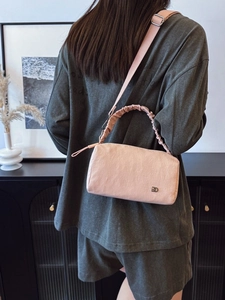 Pink pleated nylon crossbody pillow bag with adjustable strap and metal logo