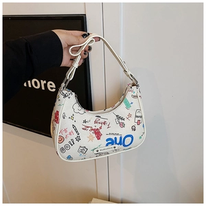 Detail of colorful graffiti patterns and silver metal hardware on white crescent bag