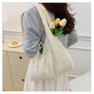 Detailed view of white floral lace tote bag featuring delicate 3D flower embroidery detail