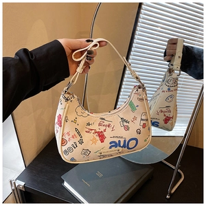 Detail of cream hobo bag featuring colorful hand-drawn graffiti and star patterns