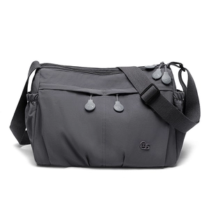 Detail of dark grey nylon crossbody bag showing multiple zip pockets and ms logo branding