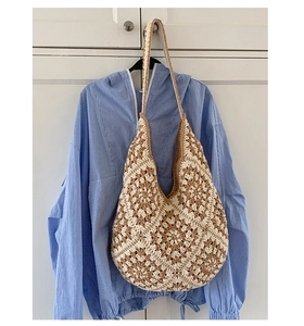 Detail of bohemian handmade crochet granny square tote bag with woven flower patterns