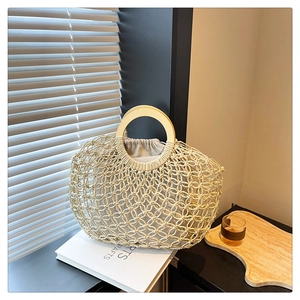Detail of hollow woven tote with round wooden handle and drawstring inner pouch