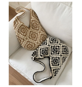 Detail of handmade crochet granny square tote bags in khaki and black floral patterns