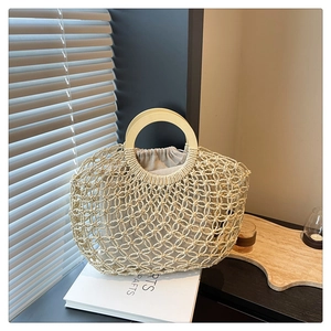 Detail of hand-woven hollow bag with round wooden handles and linen drawstring liner