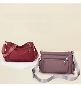 Macro detail of quilted nylon shoulder bags showing multi-pocket structure and zipper