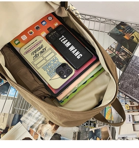 Spacious interior of khaki canvas backpack showing storage for laptop and books