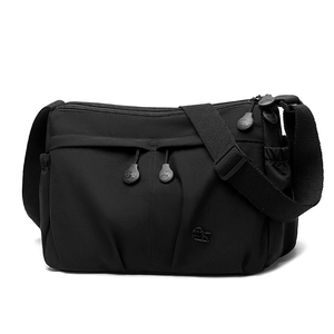 Detail view of black waterproof nylon crossbody bag with multiple zipper pockets