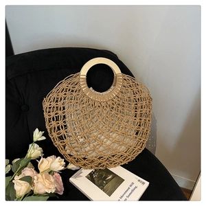 Detail of hand-woven summer tote bag with round wooden handle and cloth lining