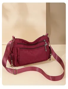 Close-up of quilted nylon crossbody bag with multiple zippers and spacious compartments
