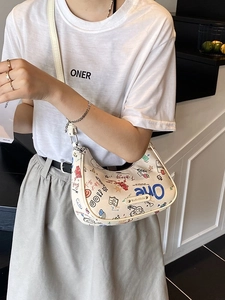 Graffiti print crescent baguette bag with colorful hand-drawn patterns and adjustable strap