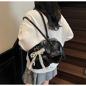 Glossy black bowling bag with heart pockets and lace bow detail on a casual shoulder strap
