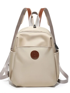 Minimalist beige nylon backpack with brown leather details for travel and school use