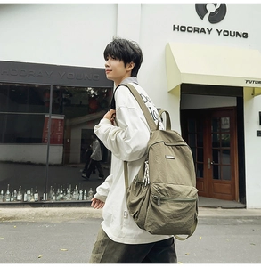 Detailed side view of Army Green nylon backpack featuring large pockets for daily commute