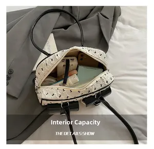 Internal capacity of white lace bow shoulder bag showing phone and cosmetics