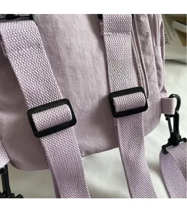 Detail of adjustable purple nylon shoulder strap with metal hook and buckle