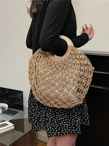 Hollow straw mesh handbag with round wooden handles and white drawstring inner pouch