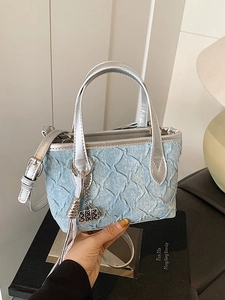 Blue quilted denim mini tote bag with metallic silver trim and removable shoulder strap