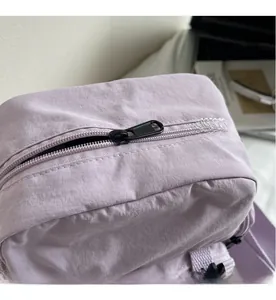 Close-up of smooth black metal zipper on durable purple canvas shoulder bag detail