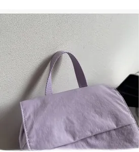 Close-up of durable light purple canvas tote bag featuring reinforced fabric top handles