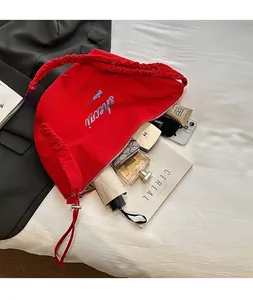 Large red crescent bag with pleated handle and spacious interior for daily essentials